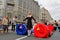 Girl in soviet school uniform and with string bags waiting for players `Cheerful start` on Tverskaya street at the City Day in Mos