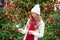 Girl with a sparkler near brightly Christmas tree