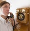 Girl speak by retro wooden phone