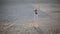 Girl spinning around herself on the sand