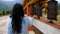 Girl spinning Buddhism religious holy wheels at monastery from flat angle