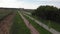 Girl is spinning on road bike on empty cycle path along river.  Woman is riding on bicycle on promenade. Healthy lifestyle and spo