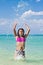 Girl splashing in the water at the beach