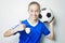 Girl in sport wear with football on white background
