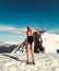 A girl in a sports black swimsuit is standing in the mountains.