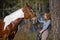 Girl sportswoman and her horse in the spring