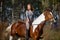 Girl sportswoman and her horse in the spring