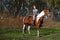 Girl sportswoman and her horse in the spring