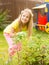 Girl sprays plants in the garden