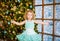 Girl spread her arms to the side near the Christmas tree