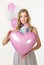 Girl in spring look with pink baloon heart. Valentine day