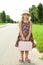 Girl standing alone on the roadside