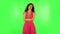 Girl standing arms crossed, nervous. Eye spasm concept. Green screen at studio