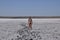 Girl standing on the dry bottom of a salt lake