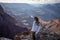 girl standing on the edge of the precipice of the grand canyon looking at the landscape