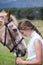 Girl standing in front of her Sabino paint horse