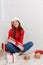 A girl is standing with a gifts wrapped against a white background