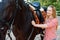 Girl standing near the horse