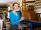 Girl standing near wicker chest of drawers