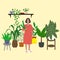 Girl is standing among plants. Everyday life of young woman with yellow watering can taking care for houseplant