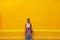 Girl standing on a street wall in Valladolid, Mexico