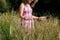 Girl Standing In Tall Grass At Park