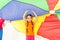 Girl standing under parti-colored parachute canopy