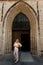 Girl standing wooden door Gothic Church