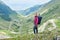 Girl stands on background of most beautiful road in Europe