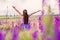 Girl stands in a field of wildflowers