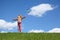 Girl stands on grass and holds windmill