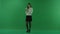 The girl stands in a half-turn, looks at the left, counts the money on the green screen