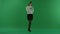 The girl stands in a half-turn, looks at the right and chat by the phone on green screen