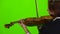 Girl stands with her back and plays the violin. Green screen. Back view. Close up