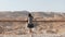 Girl stands at huge mountain view, arms wide open. Pretty European woman happy and excited. Freedom. Masada, Israel. 4K
