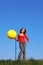 Girl stands and inflates with foot pump balloon