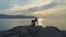 Girl stands on knees in yoga pose against boundless ocean