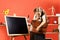 Girl stands near blackboard, copy space. Schoolgirl opens brown schoolbag