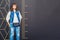 Girl stands next to a large scale ruler. Measurement of a woman in full growth. Man in denim near the wall with divisions/ Copy