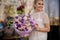 Girl stands outdoors with astonishing flower bouquet