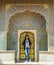 Girl stands before Rose Gate in City Palace, Jaipur, India