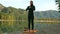 A girl stands on a sadhu Board against the background of nature in autumn. Spiritual practices on the Bank of the Katun