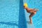 Girl stands on skirting in pool