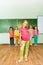 Girl stands straight near green blackboard