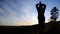 A girl stands on top of a mountain with her hands open. Freedom in the gesture.