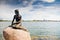 Girl statue sitting on rock