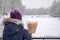 Girl is staying with cotton candy in snowfall