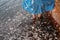 Girl staying in water near red sand wall in river