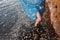 Girl staying in water near red sand wall in river