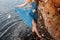 Girl staying in water near red sand wall in river